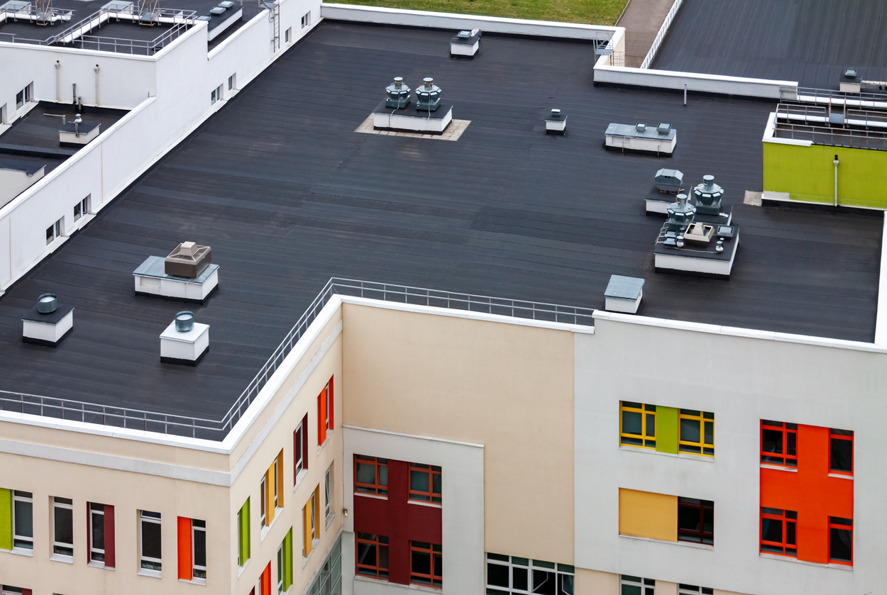 apartment building with flat roof - What is Built-Up Roofing