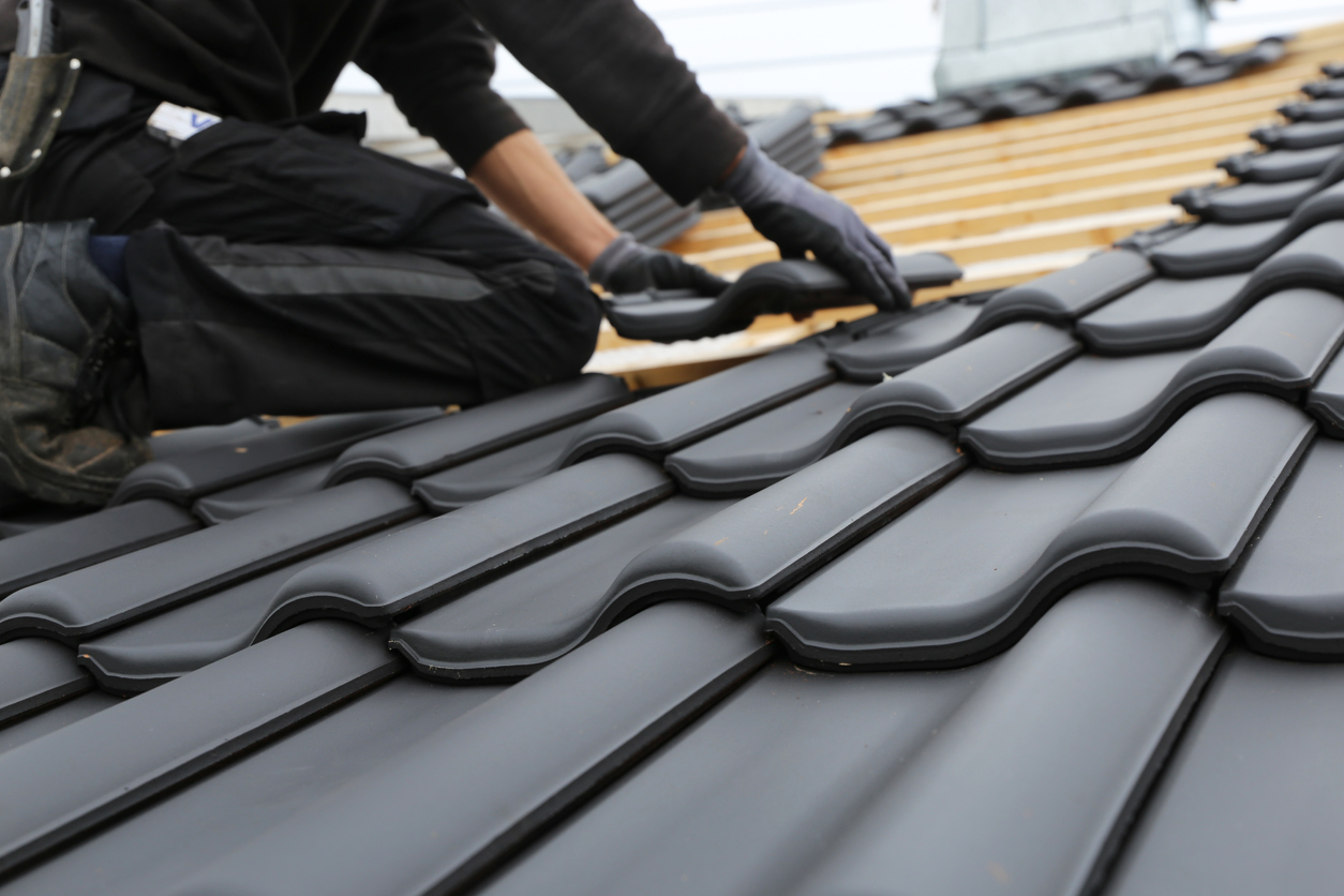 man installing fire-resistant roof materials