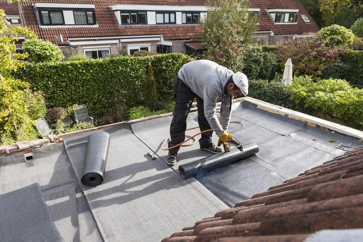 roofer installing Flat Roof Insulation